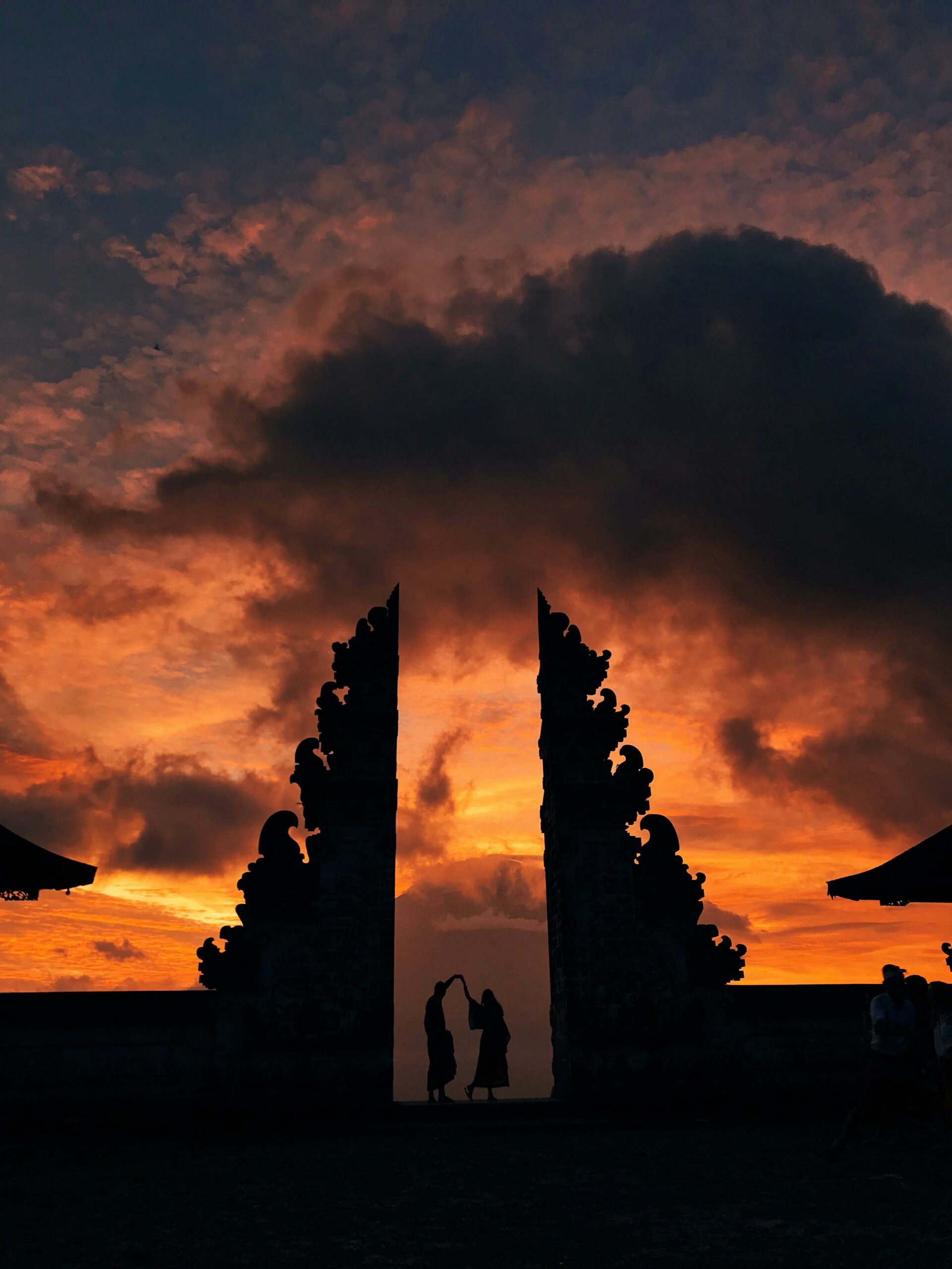A breathtaking silhouette against a dramatic sunset at Pura Lempuyang Luhur in Bali, Indonesia.